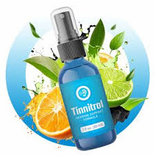 Tinnitrol sublingual hearing support spray bottle surrounded by fresh citrus fruits